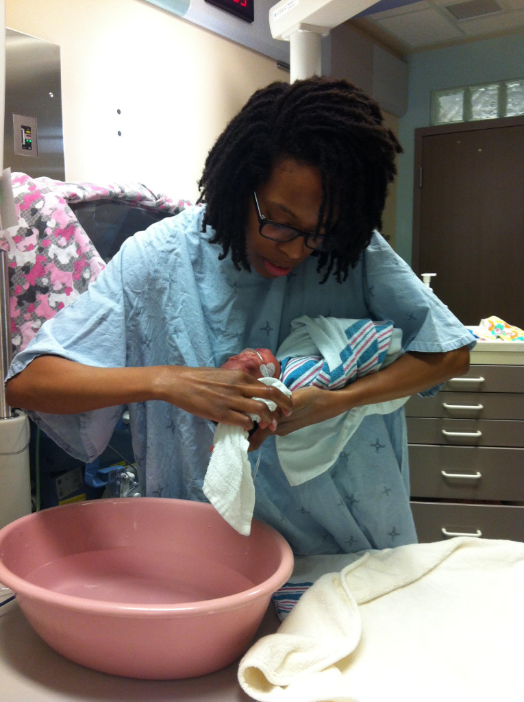 A parent learns to bathe her child in the NICU